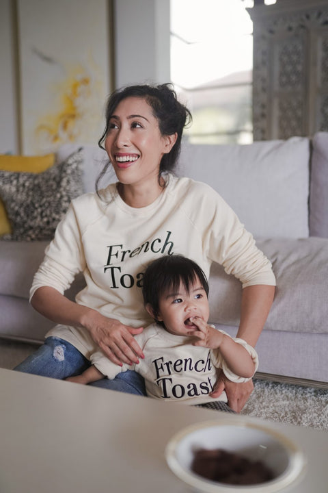 A picture of a mother and her daughter in matching sweaters made by petit moi