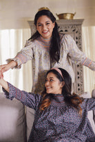 two sisters during raya having fun and smiling in their new baju kurung by petit moi