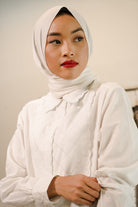 closeup of female model posing in white baju kurung by petit moi