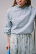 closeup shot of blue top worn by female model