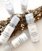 High quality hand sanitisers made by petit moi. arranged on white table with props
