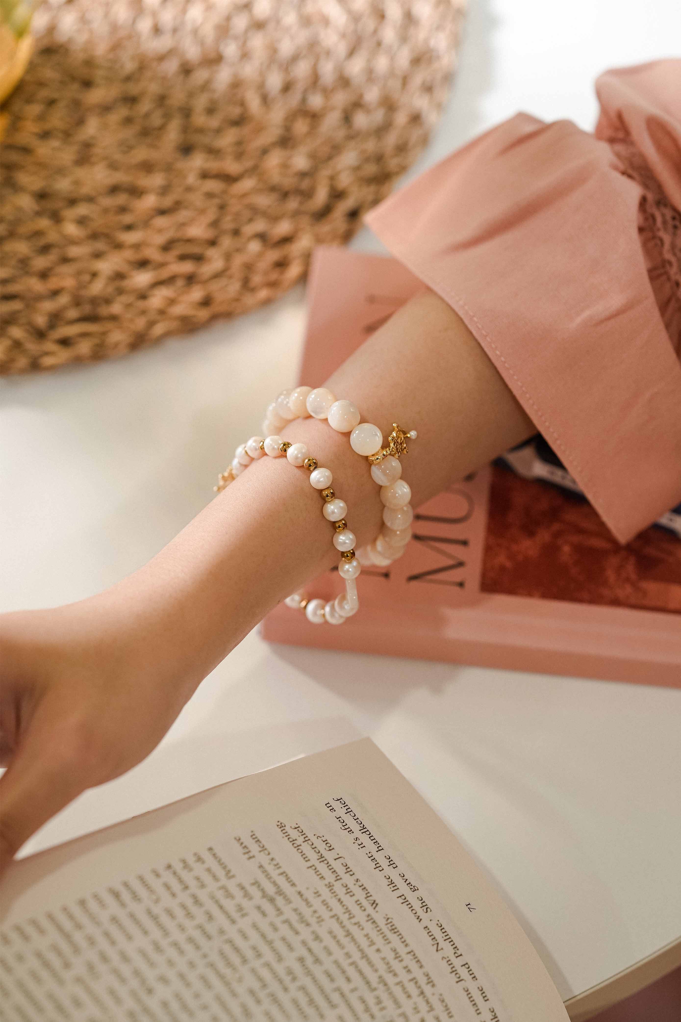 lady on table with books wearing Petit Moi bracelet