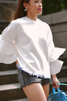 female model posing in white blouse by petit moi
