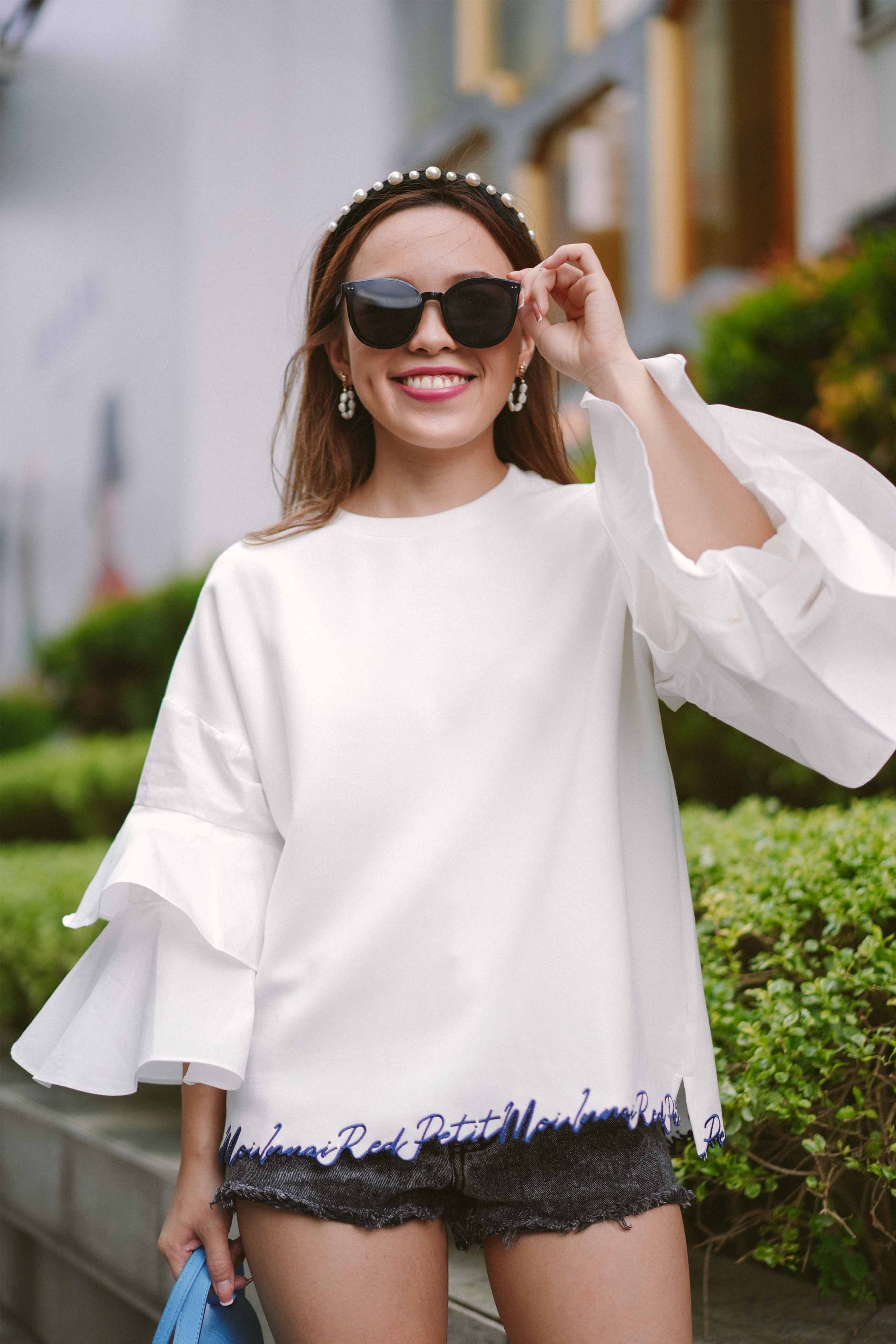 female model in sunglasses and casual white top by petit moi
