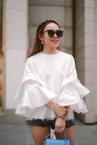 female model in white blouse by petit moi