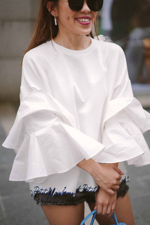 female model smiling in white blouse by petit moi