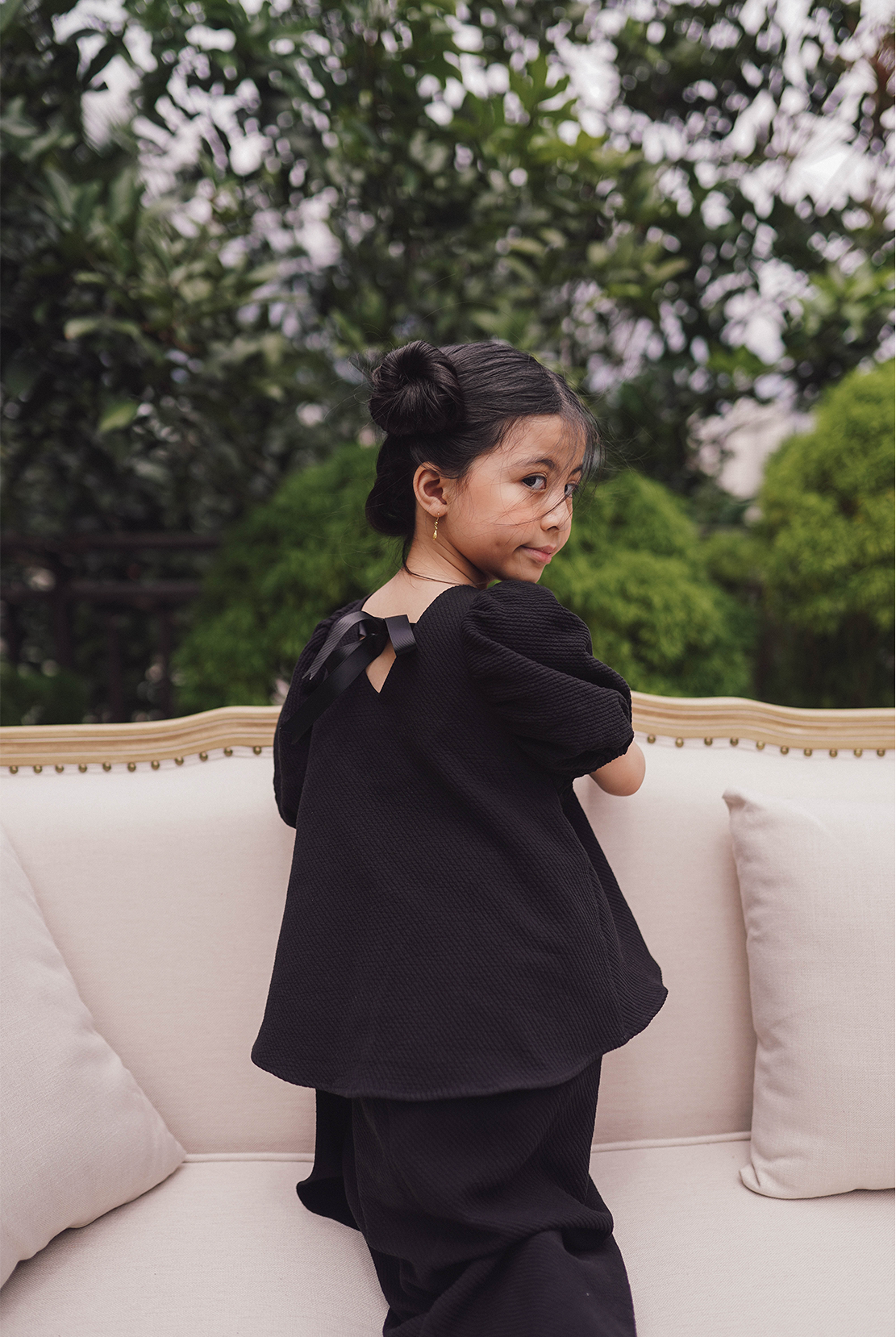 little girl model in black baju kurung made by petit moi