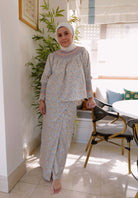 female model posing in her own home wearing comfortable and high quality baju kurung by petit moi