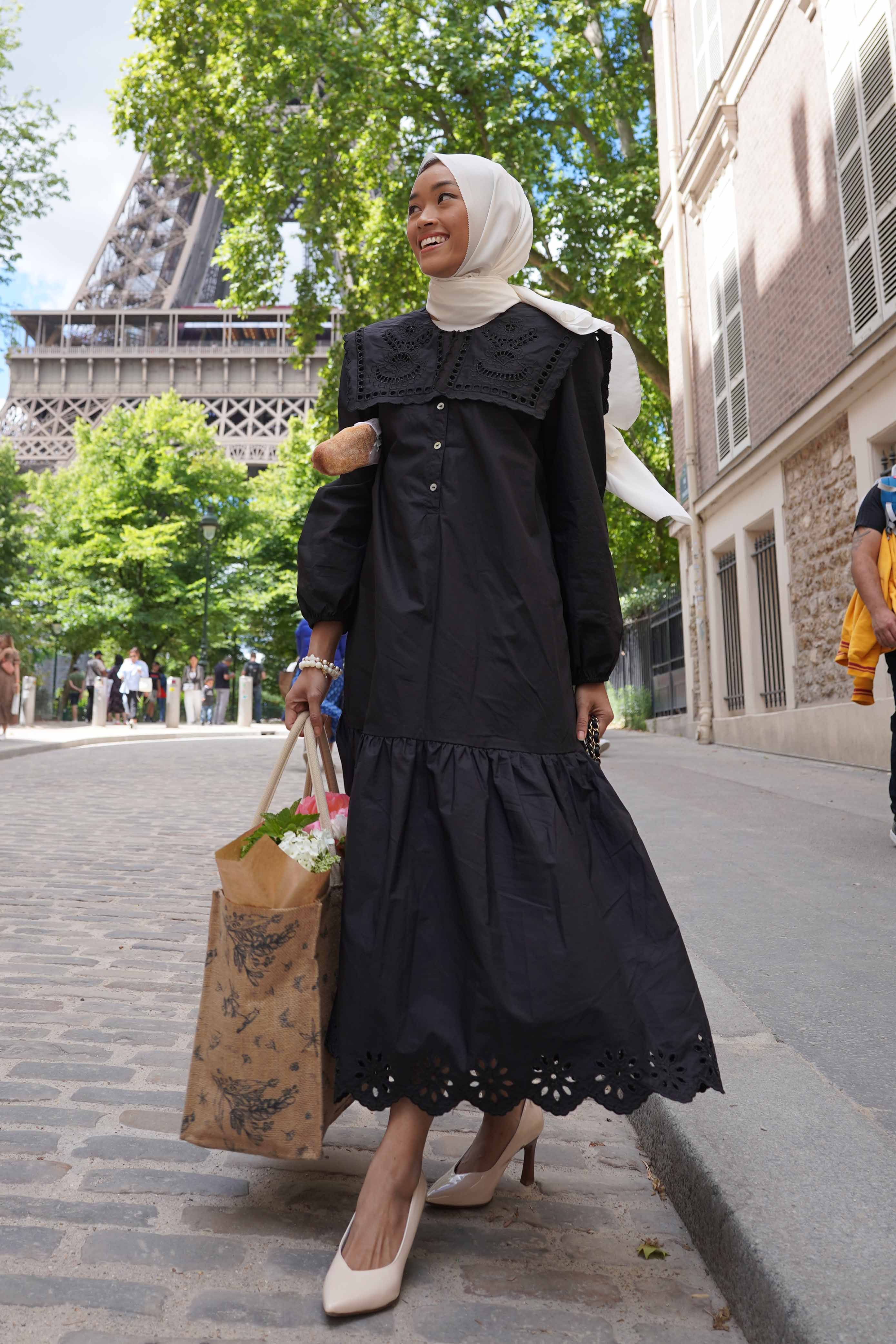 female model in paris wearing black dress made by petit moi