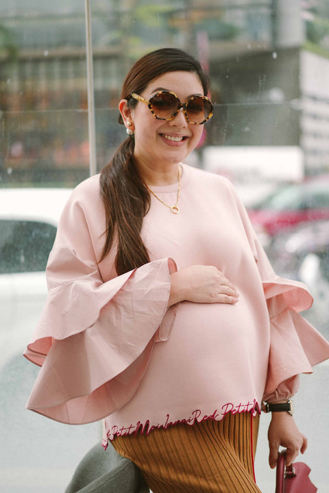 pregnant mother in pink blouse made by petit moi