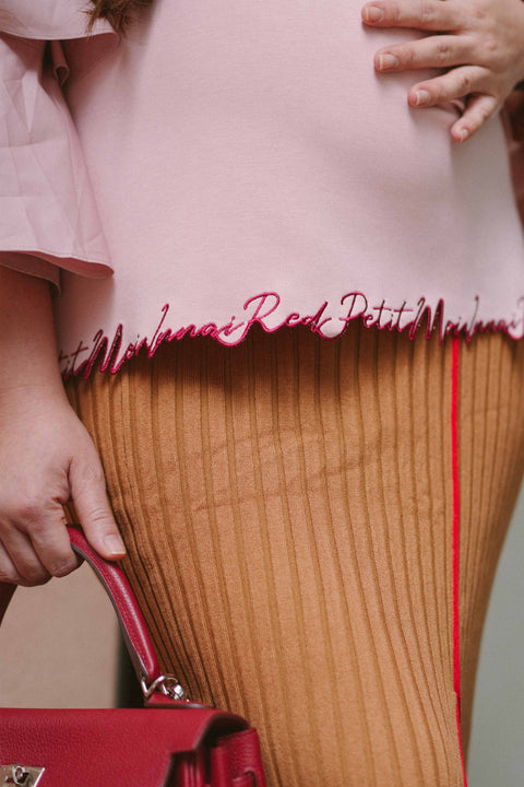 Pregnant woman in pink blouse by petit moi