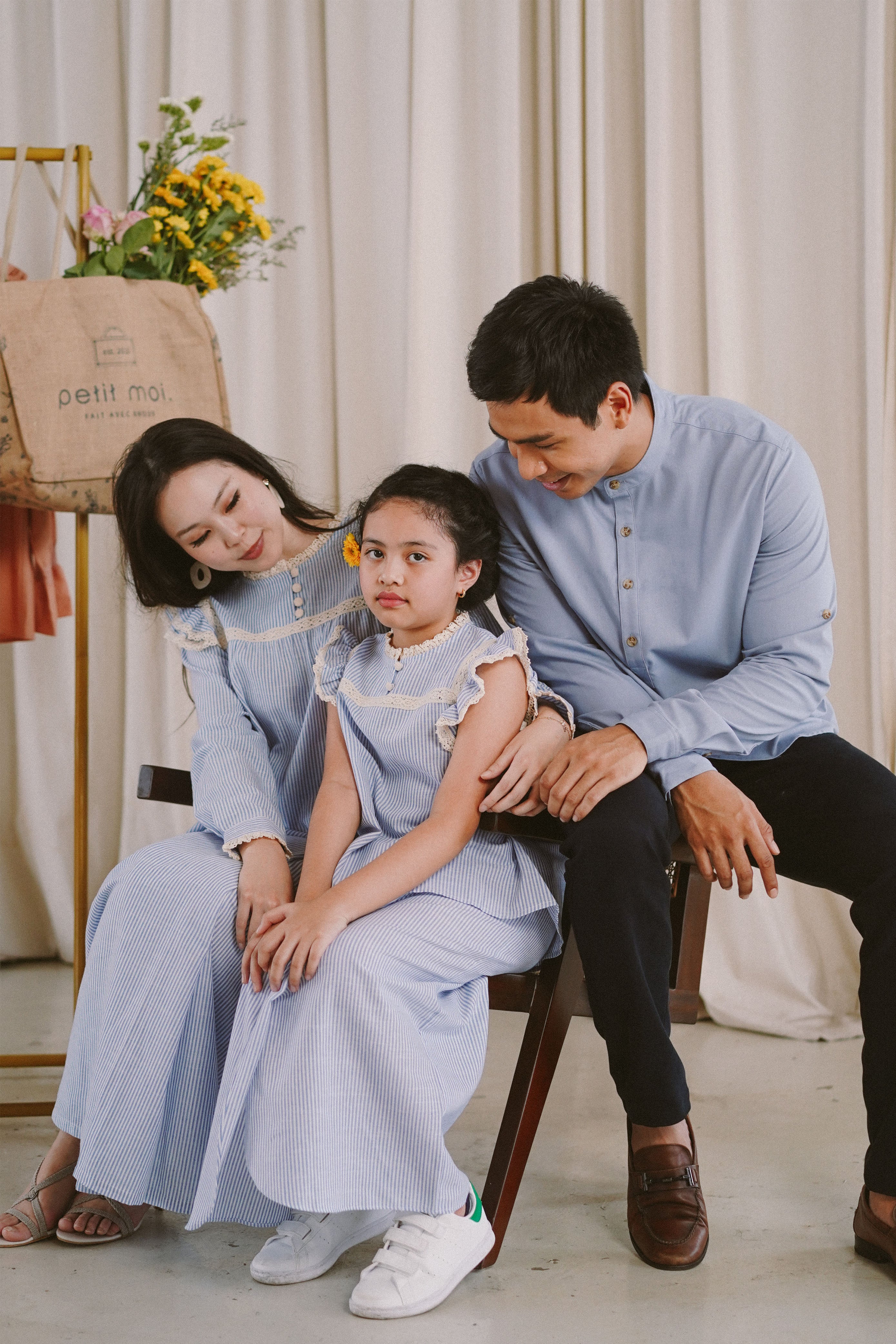 a picture of a family in modern malaysian clothing made by petit moi