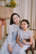 Mother and daughter in matching baju kurung made by petit moi