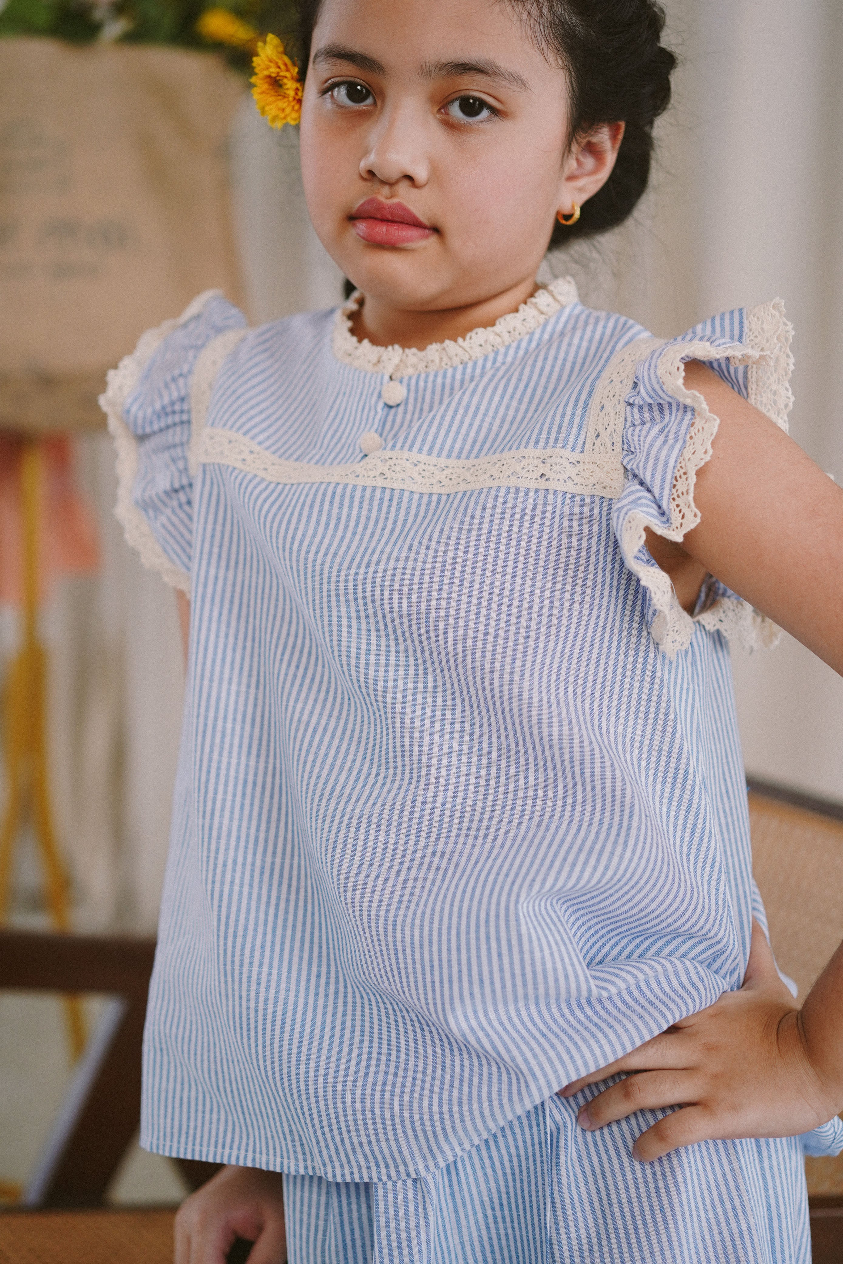 Little girl in blue and white striped baju kurung made by petit moi