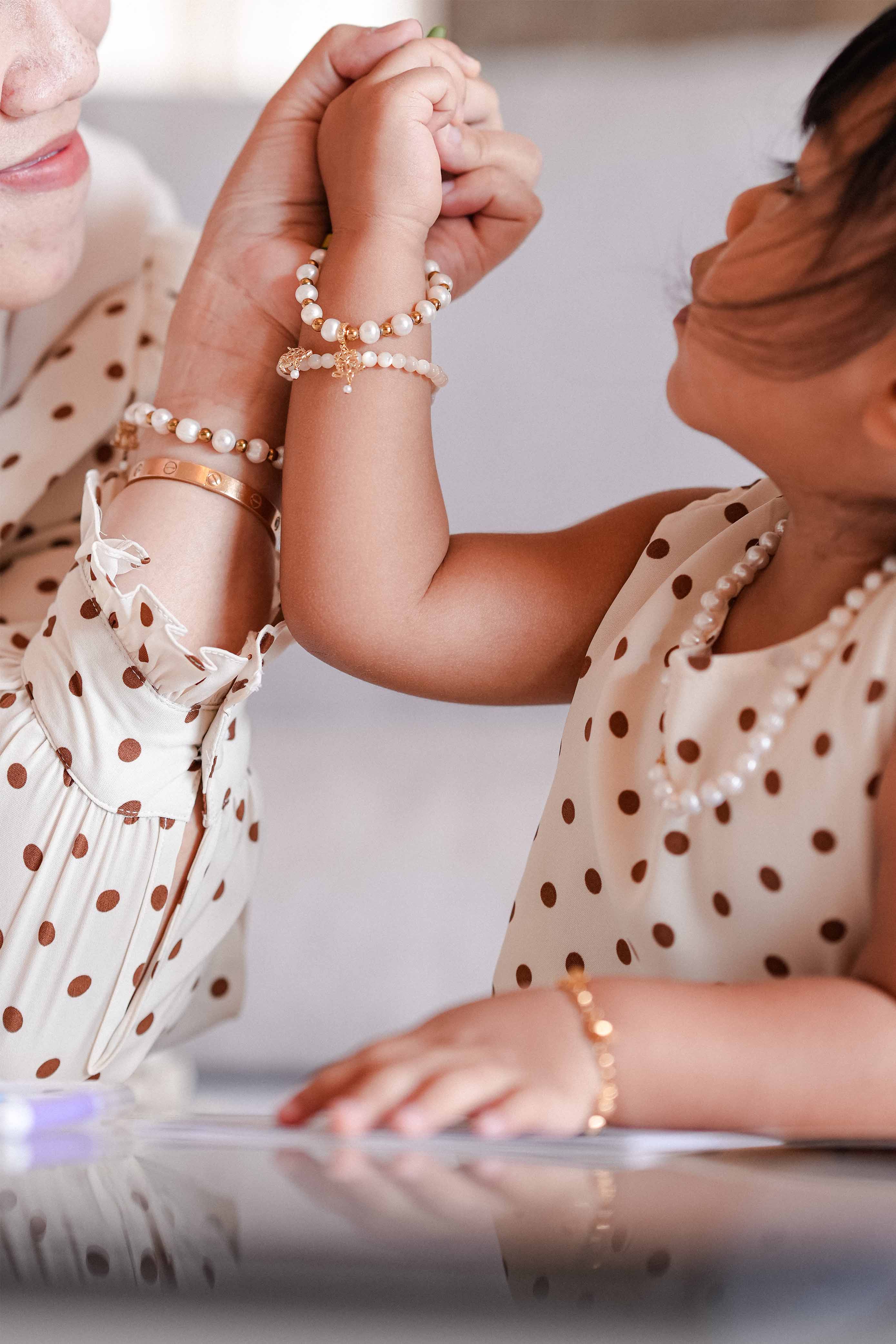 Mother and daughter in high quality matching tops and bracelets made by petit moi
