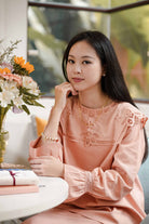 Female model in high quality pink baju kurung and bracelet made by petit moi