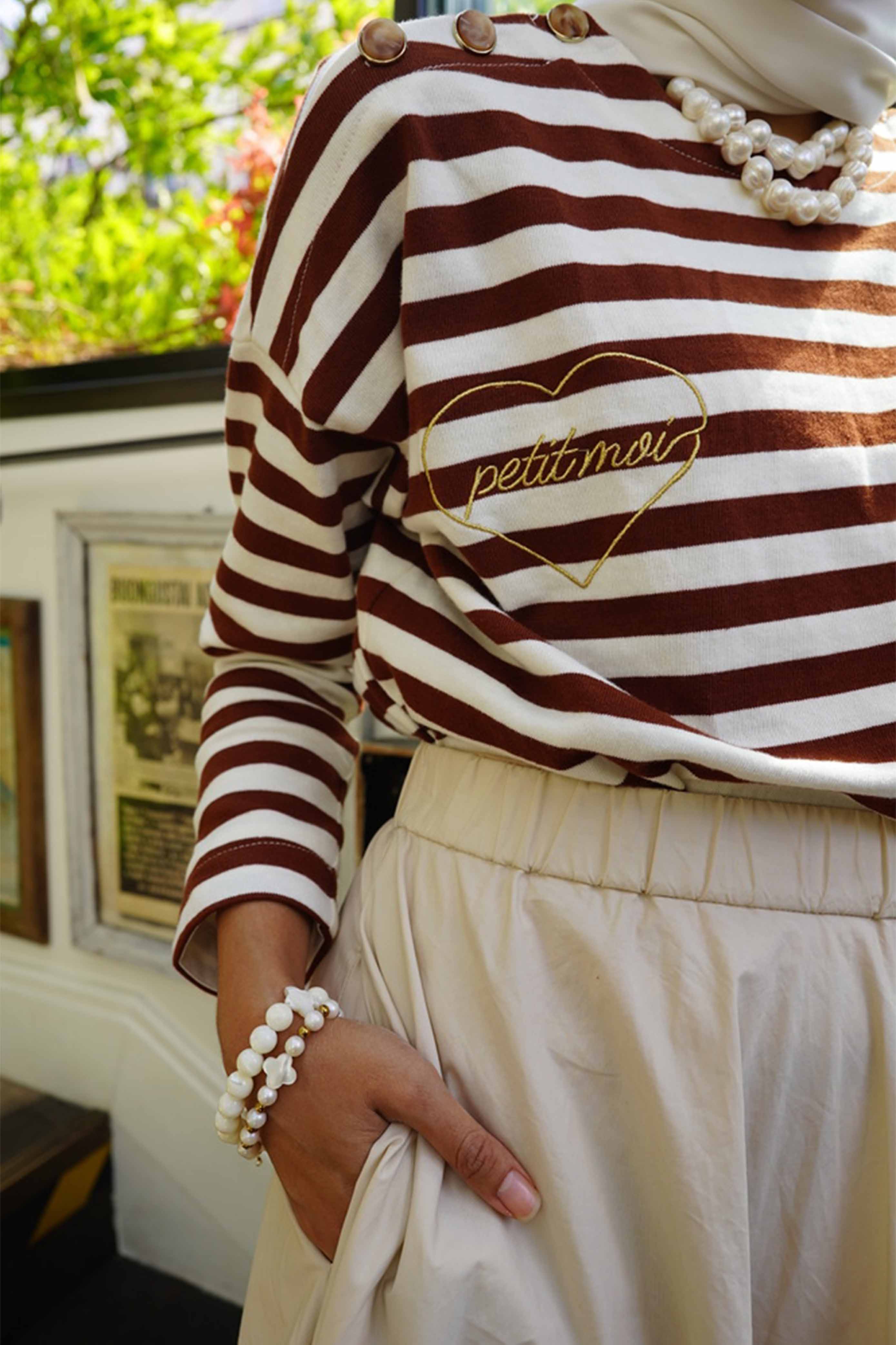 Closeup shot of high quality brown striped blouse and light brown skirt by petit moi
