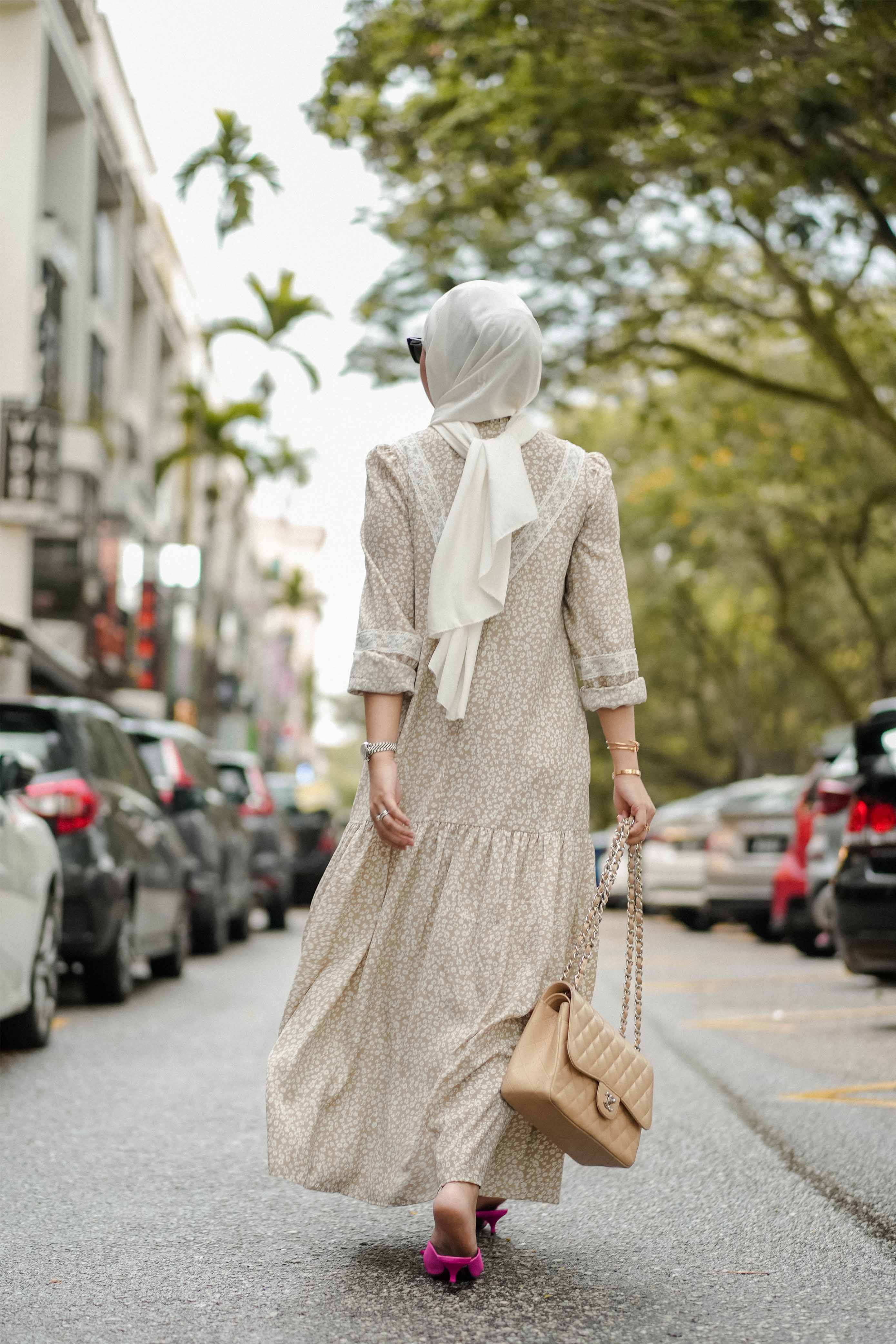 Female model walking in the middle of the road in her favourite baju kurung by petit moi