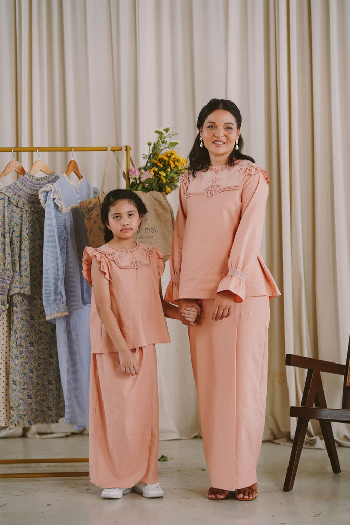 Mother and daughter in matching pink clothes made by petit moi