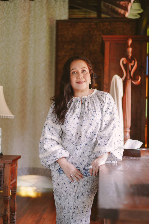 Mature woman in blue floral baju kurung made by petit moi