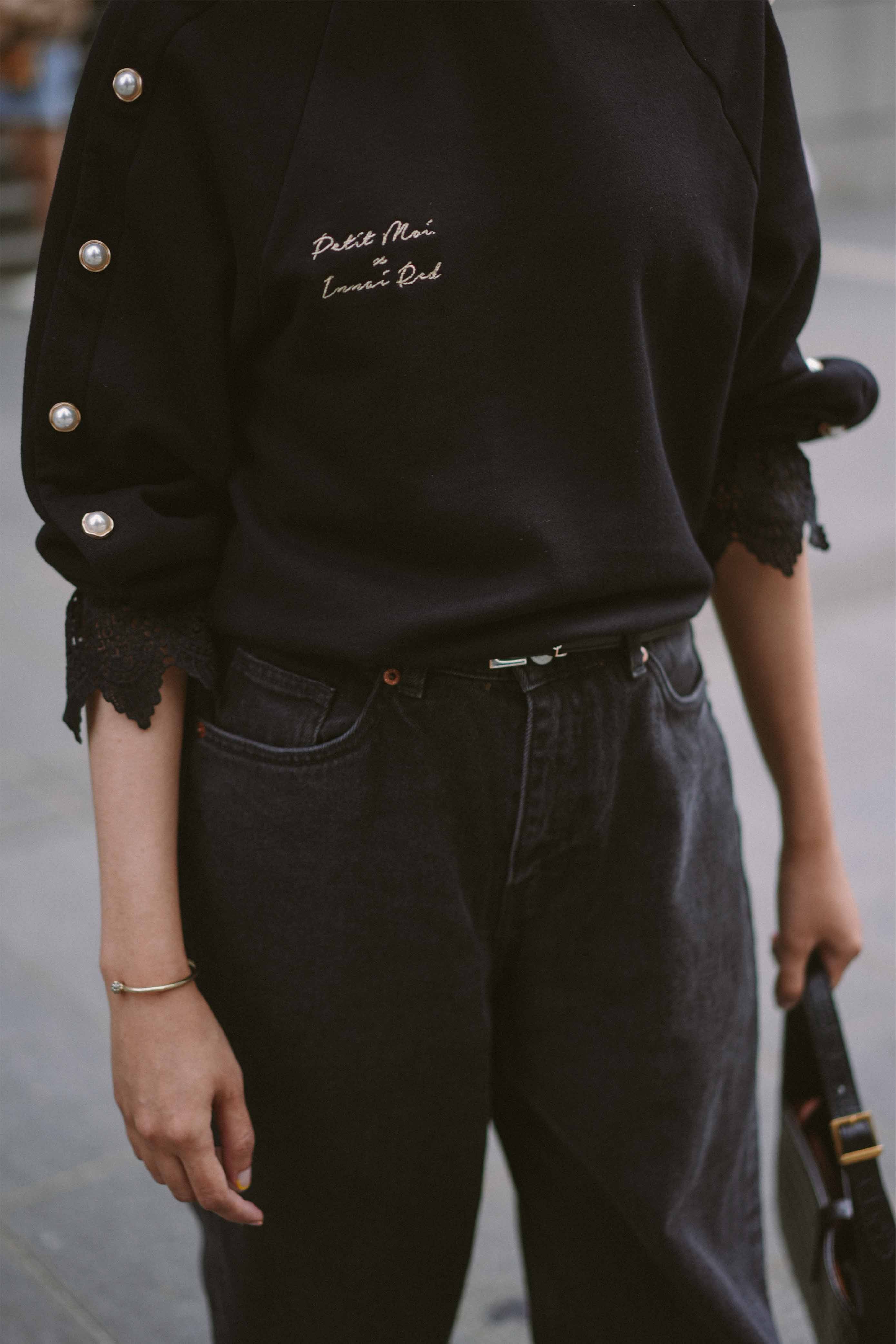 Closeup shot of black jumper worn by female model