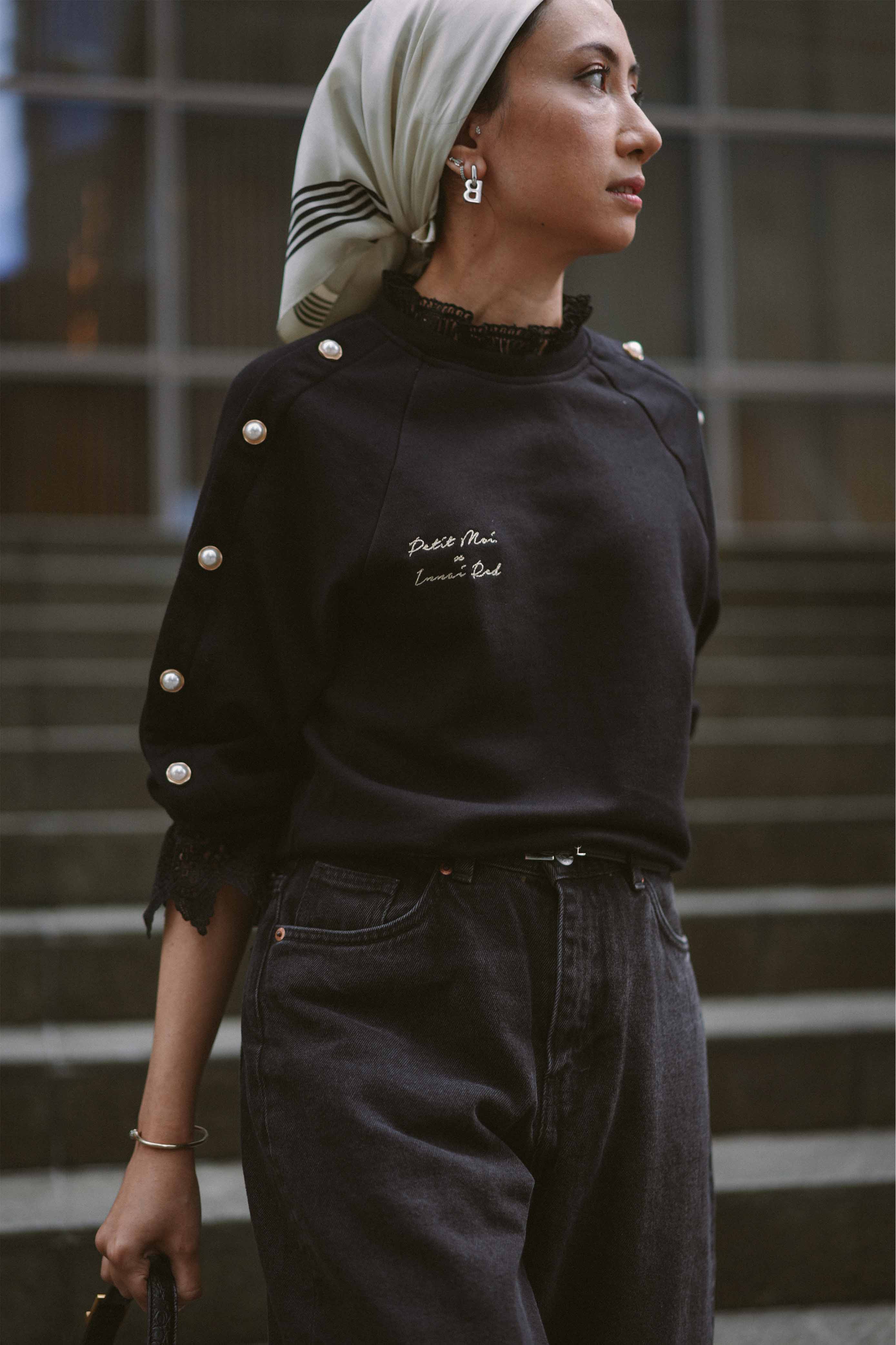 Female model wearing black jumper designed by petit moi