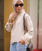 Female elderly model posing in beige jumper designed by petit moi
