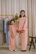 Mother and daughter wearing matching baju kurung designed by petit moi