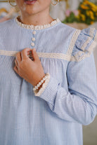 Closeup shot of blue and white striped baju kurung designed by petit moi