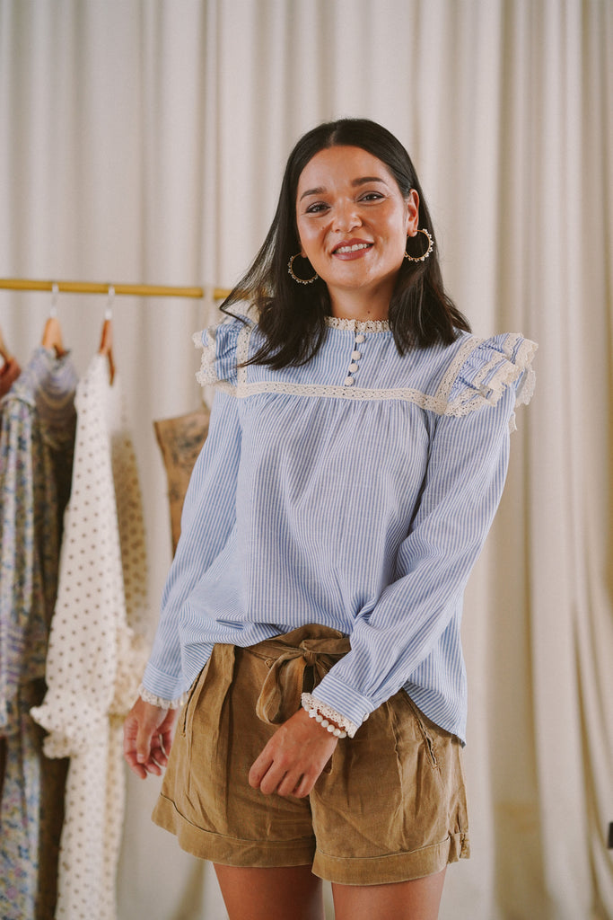female model wearing blue and white striped top designed by petit moi