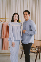 couple wearing matching blue clothes to attend for photoshoot
