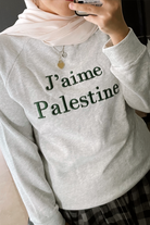 female model wearing high quality sweater by petit moi. Design inspired by the love for Palestine