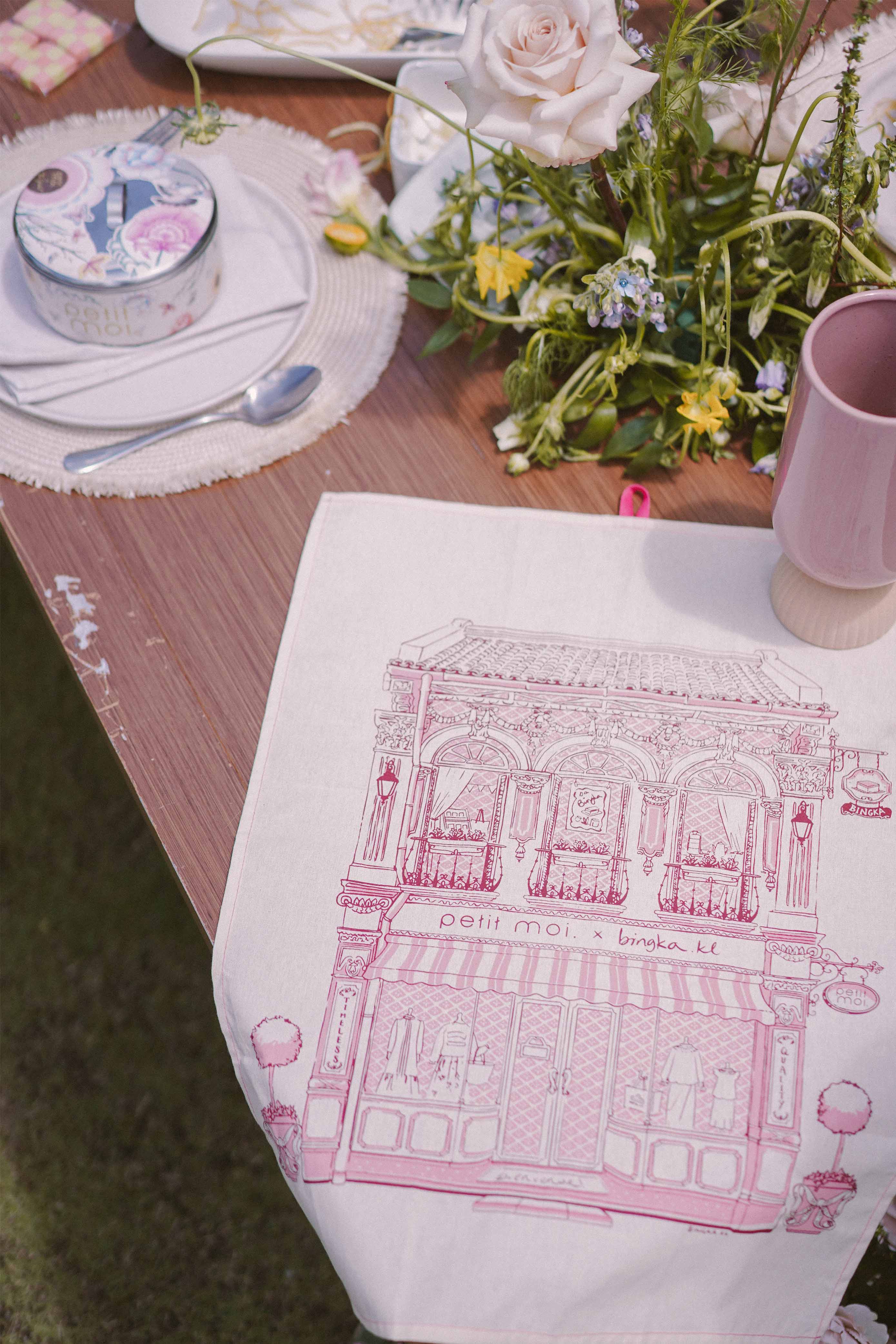 Petit Moi pink bingka tea towel and cup on table