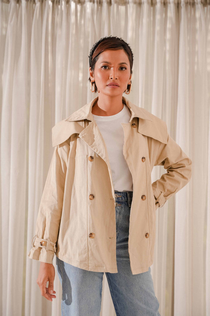 female model wearing high quality trench coat whilst posing for the camera
