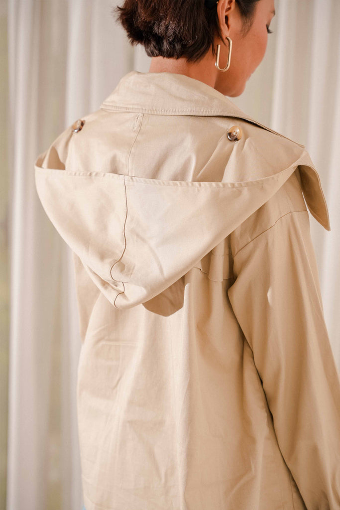 closeup back shot of female model wearing high quality trench coat designed by petit moi