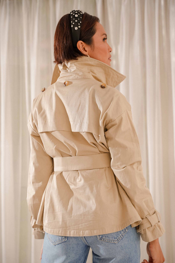 closeup back shot of female model wearing her brand new high quality trench coat by petit moi