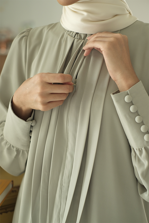 Closeup shot of high quality sage green dress by petit moi