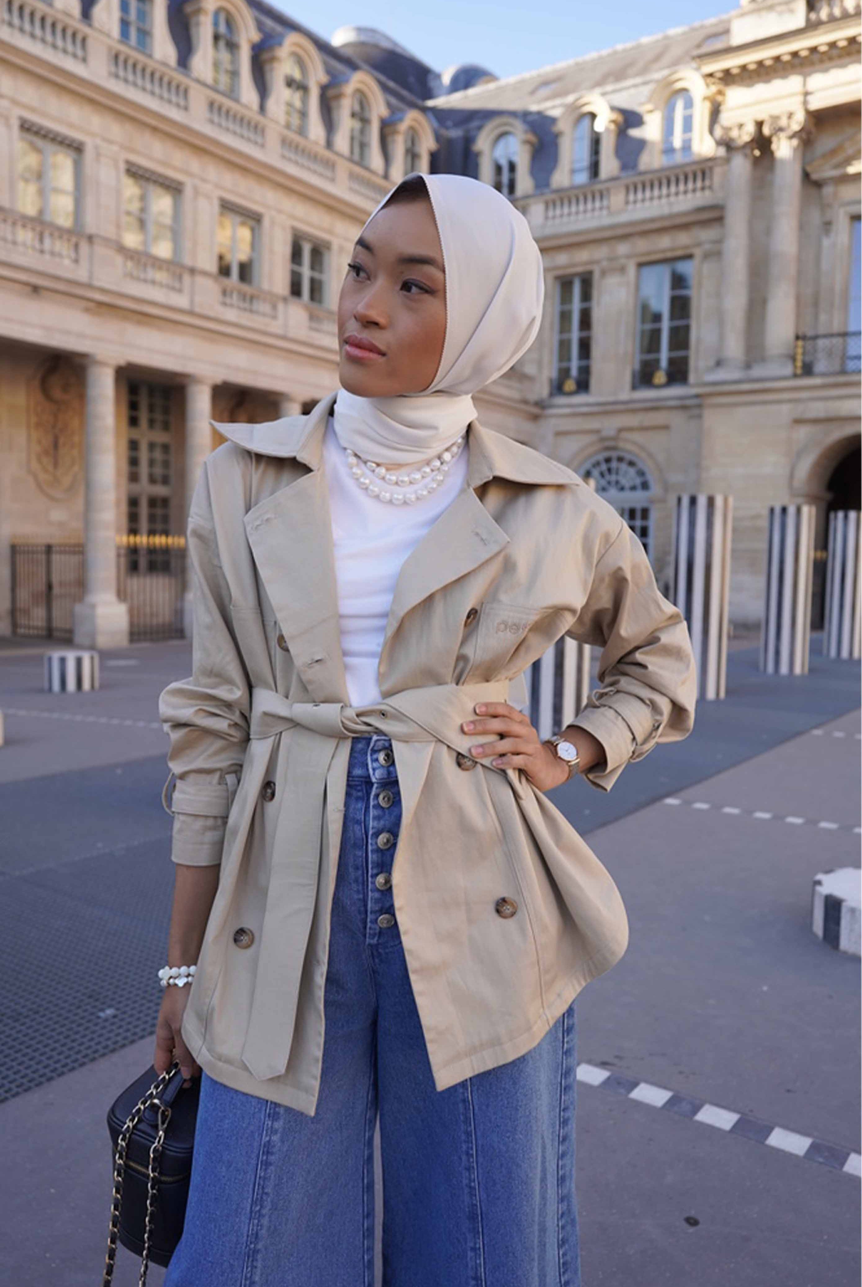 female model in paris posing in comfortable and high quality trench coat 