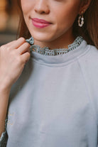 Closeup shot of blue top worn by female model and designed by petit moi